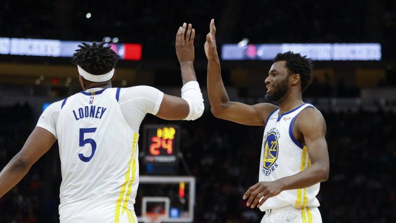 Jan 31, 2022; Houston, Texas, USA; Golden State Warriors center Kevon Looney (5) celebrates with forward Andrew Wiggins (22) after a play during the fourth quarter against the Houston Rockets at Toyota Center. Mandatory Credit: Troy Taormina-USA TODAY Sports