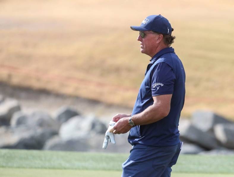 Phil Mickelson gives advice to an amateur in his group while playing the 11th green of the Pete Dye Stadium course during the third round of The American Express at PGA West in La Quinta, Calif., Saturday, Jan. 22, 2022.

Syndication Desert Sun