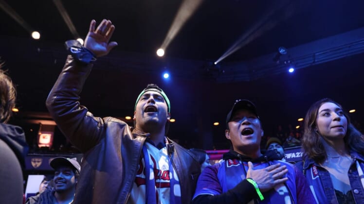 Fans Mark Escamilla, left, and John Chun, right, cheer for Austin FC eMLS player John Garcia during the eMLS Cup tournament at the Moody Theater on March 13, 2022. The eMLS Cup is the championship tournament that determines which player is the best FIFA esports player in North America.Aem Sxsw Emls Cup 17