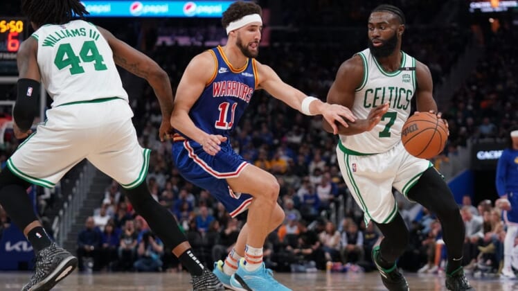 Mar 16, 2022; San Francisco, California, USA; Boston Celtics guard Jaylen Brown (7) dribbles the ball next to Golden State Warriors guard Klay Thompson (11) in the third quarter at the Chase Center. Mandatory Credit: Cary Edmondson-USA TODAY Sports