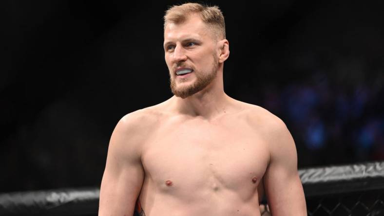 Mar 19, 2022; London, UK; Alexander Volkov (red gloves) and Tom Aspinall (blue gloves) during UFC Fight Night at O2 Arena. Mandatory Credit: Per Haljestam-USA TODAY Sports