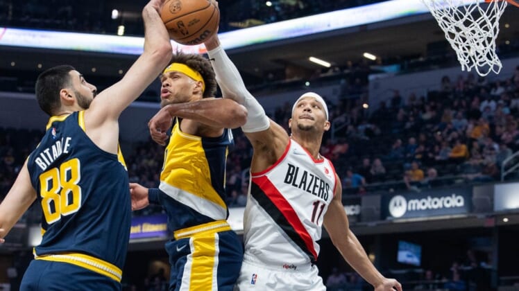 Mar 20, 2022; Indianapolis, Indiana, USA; Indiana Pacers center Goga Bitadze (88) and Portland Trail Blazers guard Josh Hart (11) fight for a rebound over Indiana Pacers forward Justin Anderson (10) in the first half at Gainbridge Fieldhouse. Mandatory Credit: Trevor Ruszkowski-USA TODAY Sports