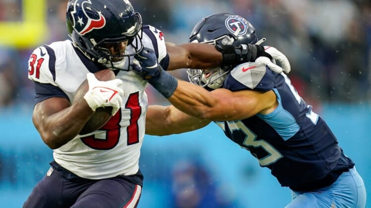 Houston Texans running back David Johnson (31) takes a hit from Tennessee Titans linebacker Dylan Cole (53) during the second quarter at Nissan Stadium in Nashville, Tenn., Sunday, Nov. 21, 2021.Titans Texans 112121 Aan 012