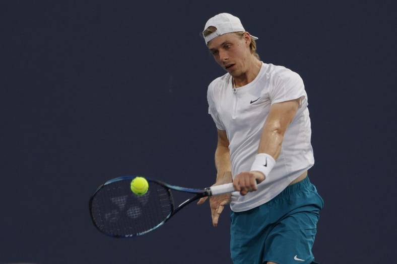 Mar 26, 2022; Miami Gardens, FL, USA; Denis Shapovalov (CAN) hits a backhand against Lloyd Harris (RSA)(not pictured) in a second round men's singles match in the Miami Open at Hard Rock Stadium. Mandatory Credit: Geoff Burke-USA TODAY Sports