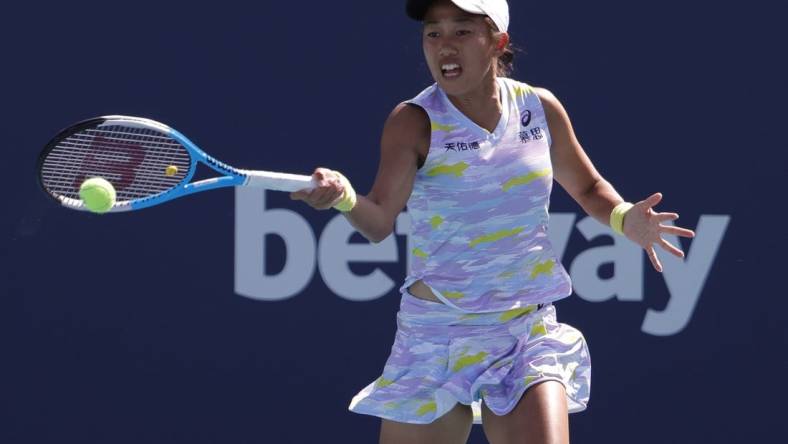 Mar 27, 2022; Miami Gardens, FL, USA; Shuai Zhang hits a forehand against Coco Gauff (USA) in a third round women's singles match in the Miami Open at Hard Rock Stadium. Mandatory Credit: Geoff Burke-USA TODAY Sports