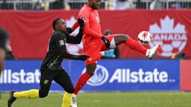 Mar 27, 2022; Toronto, Ontario, CAN;   Canada defender Doneil Henry (15) controls the ball against Jamaica midfielder Atapharoy Bygrave (18) in the second half of a FIFA World Cup qualifying soccer match at BMO Field. Mandatory Credit: Dan Hamilton-USA TODAY Sports
