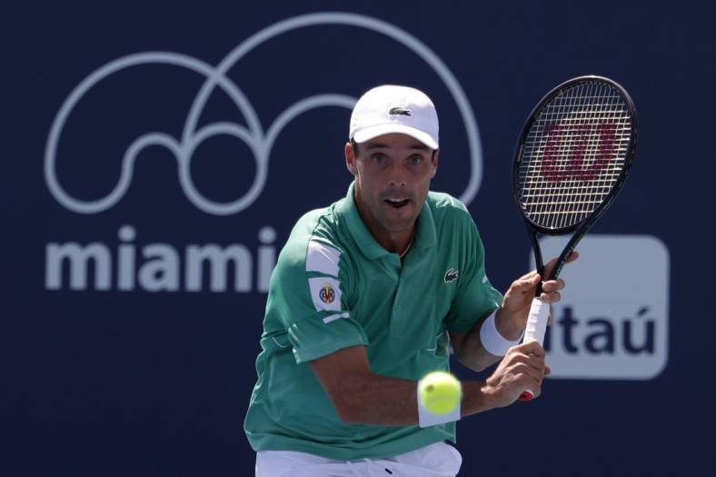 Mar 28, 2022; Miami Gardens, FL, USA; Roberto Bautista Agut (ESP) hits a backhand against Jenson Brooksby (USA)(not pictured) in a third round men's singles match in the Miami Open at Hard Rock Stadium. Mandatory Credit: Geoff Burke-USA TODAY Sports