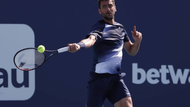 Mar 28, 2022; Miami Gardens, FL, USA; Marin Cilic (CRO) hits a forehand against Carlos Alcaraz (ESP)(not pictured) in a third round men's singles match in the Miami Open at Hard Rock Stadium. Mandatory Credit: Geoff Burke-USA TODAY Sports