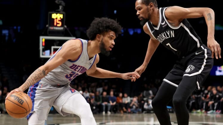 Mar 29, 2022; Brooklyn, New York, USA; Detroit Pistons forward Marvin Bagley III (35) controls the ball against Brooklyn Nets forward Kevin Durant (7) during the first quarter at Barclays Center. Mandatory Credit: Brad Penner-USA TODAY Sports