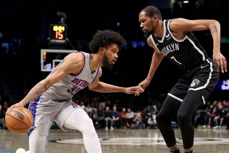 Mar 29, 2022; Brooklyn, New York, USA; Detroit Pistons forward Marvin Bagley III (35) controls the ball against Brooklyn Nets forward Kevin Durant (7) during the first quarter at Barclays Center. Mandatory Credit: Brad Penner-USA TODAY Sports