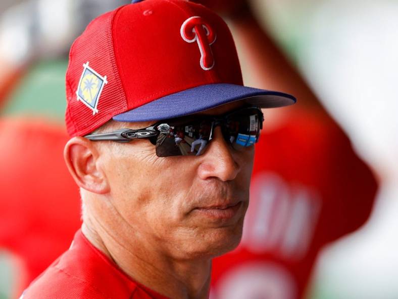 Mar 31, 2022; Clearwater, Florida, USA; Philadelphia Phillies manager Joe Girardi  (25) looks on from the dugout in the sixth inning against the New York Yankees during spring training at BayCare Ballpark. Mandatory Credit: Nathan Ray Seebeck-USA TODAY Sports