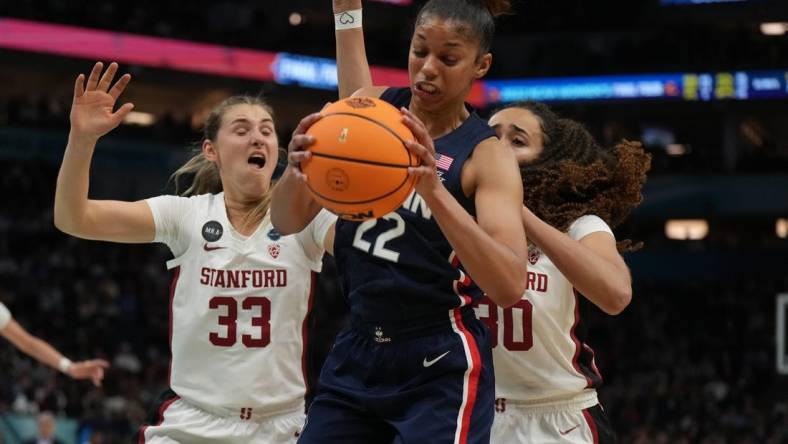 Apr 1, 2022; Minneapolis, MN, USA; UConn Huskies guard Evina Westbrook (22) battles for a rebound with Stanford Cardinal guard Hannah Jump (33) and Stanford Cardinal guard Haley Jones (30) during the second half in the Final Four semifinals of the women's college basketball NCAA Tournament at Target Center. Mandatory Credit: Kirby Lee-USA TODAY Sports
