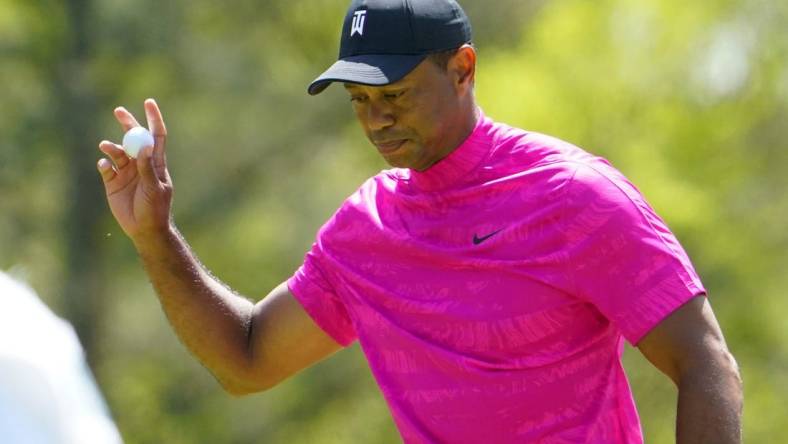 Apr 7, 2022; Augusta, Georgia, USA; Tiger Woods waves to the crowd after sinking a putt on no. 6 during the first round of The Masters golf tournament at Augusta National Golf Club. Mandatory Credit: Danielle Parhizkaran-Augusta Chronicle/USA TODAY Sports