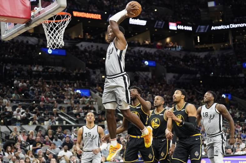 Apr 9, 2022; San Antonio, Texas, USA; San Antonio Spurs guard Lonnie Walker IV (1) dunks against the Golden State Warriors during the first half at AT&T Center. Mandatory Credit: Scott Wachter-USA TODAY Sports