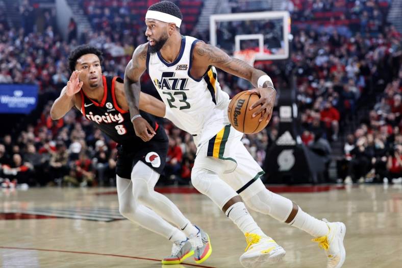 Apr 10, 2022; Portland, Oregon, USA; Utah Jazz power forward Royce O'Neale (23) dribbles the ball while defended by  Portland Trail Blazers point guard Brandon Williams (8) during the first half at Moda Center. Mandatory Credit: Soobum Im-USA TODAY Sports