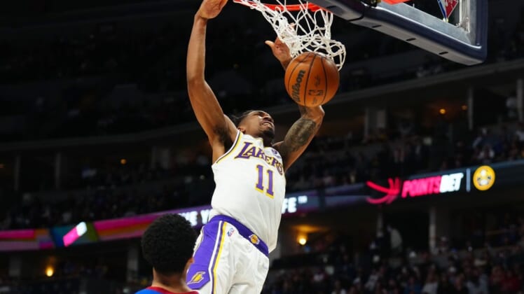 Apr 10, 2022; Denver, Colorado, USA; Los Angeles Lakers guard Malik Monk (11) finishes off a basket in the second half against the Denver Nuggets at Ball Arena. Mandatory Credit: Ron Chenoy-USA TODAY Sports