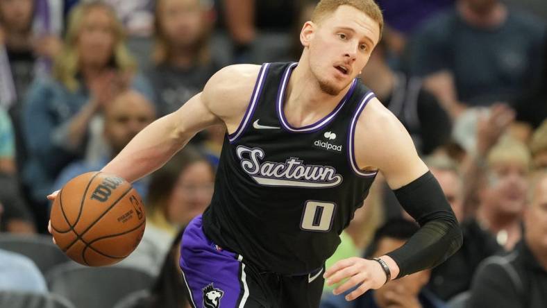 Apr 3, 2022; Sacramento, California, USA; Sacramento Kings guard Donte DiVincenzo (0) dribbles during the fourth quarter against the Golden State Warriors at Golden 1 Center. Mandatory Credit: Darren Yamashita-USA TODAY Sports