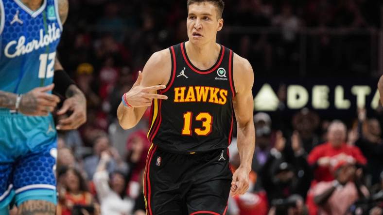 Apr 13, 2022; Atlanta, Georgia, USA; Atlanta Hawks guard Bogdan Bogdanovic (13) reacts after making a three point shot against the Charlotte Hornets during the first half at State Farm Arena. Mandatory Credit: Dale Zanine-USA TODAY Sports