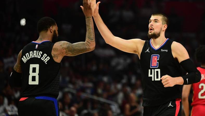 Apr 15, 2022; Los Angeles, California, USA; Los Angeles Clippers center Ivica Zubac (40) is greeted by forward Marcus Morris Sr. (8) against the New Orleans Pelicans during the first half of the play in game at Crypto.com Arena. Mandatory Credit: Gary A. Vasquez-USA TODAY Sports