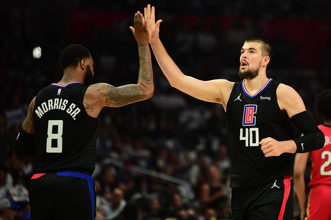 Apr 15, 2022; Los Angeles, California, USA; Los Angeles Clippers center Ivica Zubac (40) is greeted by forward Marcus Morris Sr. (8) against the New Orleans Pelicans during the first half of the play in game at Crypto.com Arena. Mandatory Credit: Gary A. Vasquez-USA TODAY Sports