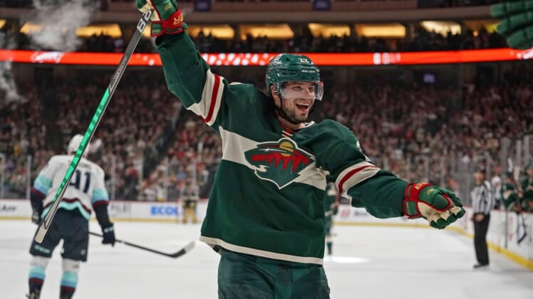 Apr 22, 2022; Saint Paul, Minnesota, USA; Minnesota Wild left wing Kevin Fiala (22) celebrates his fifth assist of the night against the Seattle Kraken on a goal scored by Minnesota Wild forward Nicolas Deslauriers (not pictured) during the second period at Xcel Energy Center. Mandatory Credit: Nick Wosika-USA TODAY Sports