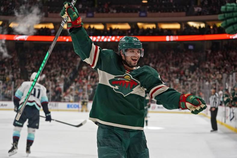 Apr 22, 2022; Saint Paul, Minnesota, USA; Minnesota Wild left wing Kevin Fiala (22) celebrates his fifth assist of the night against the Seattle Kraken on a goal scored by Minnesota Wild forward Nicolas Deslauriers (not pictured) during the second period at Xcel Energy Center. Mandatory Credit: Nick Wosika-USA TODAY Sports