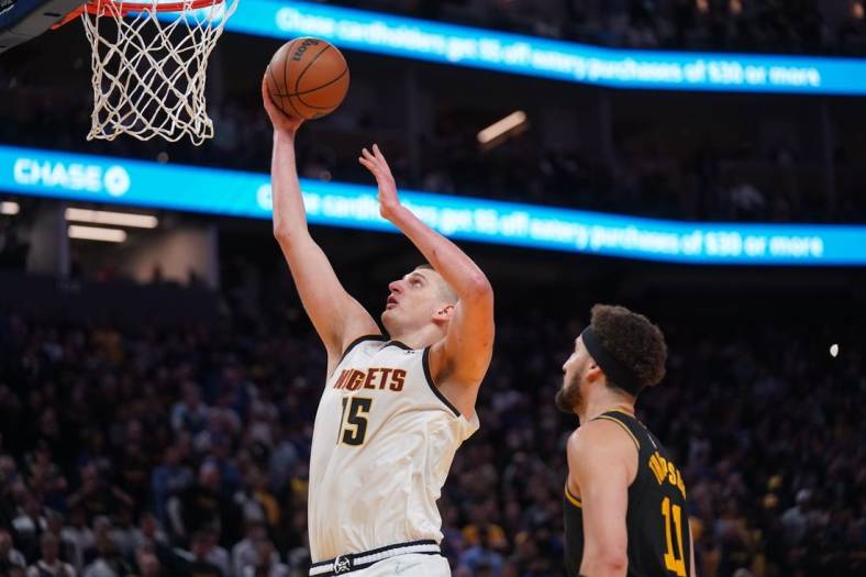 Apr 27, 2022; San Francisco, California, USA; Denver Nuggets center Nikola Jokic (15) makes a basket in front of Golden State Warriors guard Klay Thompson (11) in the fourth quarter during game five of the first round for the 2022 NBA playoffs at Chase Center. Mandatory Credit: Cary Edmondson-USA TODAY Sports