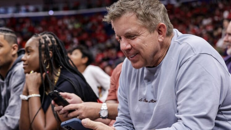 Apr 28, 2022; New Orleans, Louisiana, USA;  Former New Orleans Saints head coach Sean Payton looks at his phone on a time out during the first half of game six of the first round for the 2022 NBA playoffs at Smoothie King Center. Mandatory Credit: Stephen Lew-USA TODAY Sports