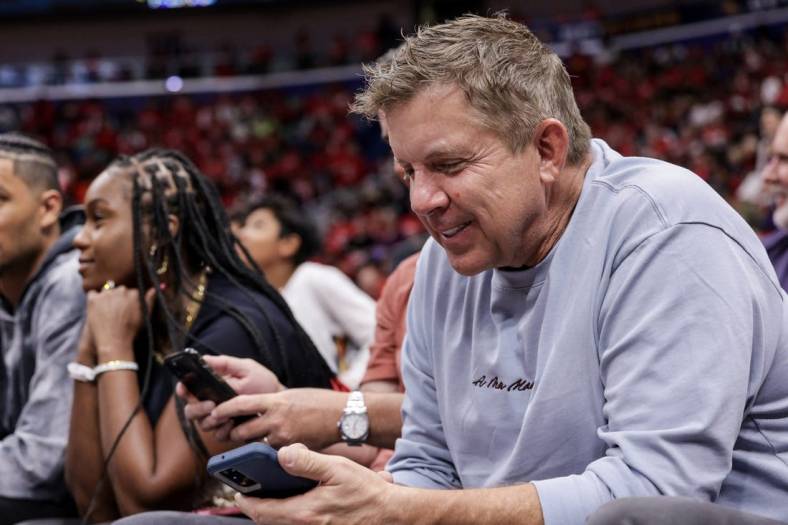 Apr 28, 2022; New Orleans, Louisiana, USA;  Former New Orleans Saints head coach Sean Payton looks at his phone on a time out during the first half of game six of the first round for the 2022 NBA playoffs at Smoothie King Center. Mandatory Credit: Stephen Lew-USA TODAY Sports