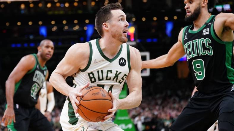 May 1, 2022; Boston, Massachusetts, USA; Milwaukee Bucks guard Pat Connaughton (24) drives the ball against Boston Celtics guard Derrick White (9) in the second half during game one of the second round for the 2022 NBA playoffs at TD Garden. Mandatory Credit: David Butler II-USA TODAY Sports