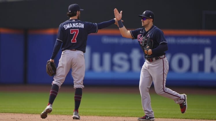 May 4, 2022; New York City, New York, USA; Atlanta Braves shortstop Dansby Swanson (7) and Atlanta Braves center fielder Adam Duvall (14) hi five to celebrate the victory after the ninth inning against the New York Mets at Citi Field. Mandatory Credit: Gregory Fisher-USA TODAY Sports