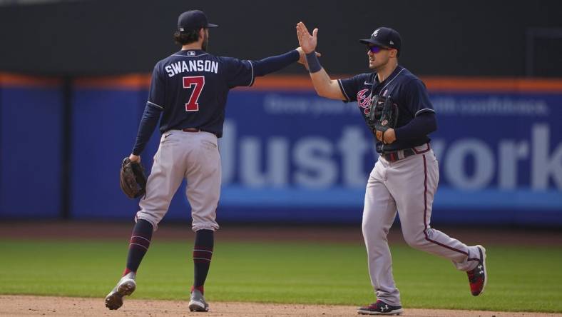 May 4, 2022; New York City, New York, USA; Atlanta Braves shortstop Dansby Swanson (7) and Atlanta Braves center fielder Adam Duvall (14) hi five to celebrate the victory after the ninth inning against the New York Mets at Citi Field. Mandatory Credit: Gregory Fisher-USA TODAY Sports