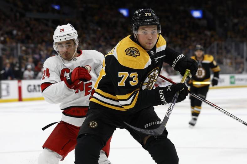 May 6, 2022; Boston, Massachusetts, USA; Boston Bruins defenseman Charlie McAvoy (73) gets position on Carolina Hurricanes center Seth Jarvis (24) during the third period in game three of the first round of the 2022 Stanley Cup Playoffs at TD Garden. Mandatory Credit: Winslow Townson-USA TODAY Sports