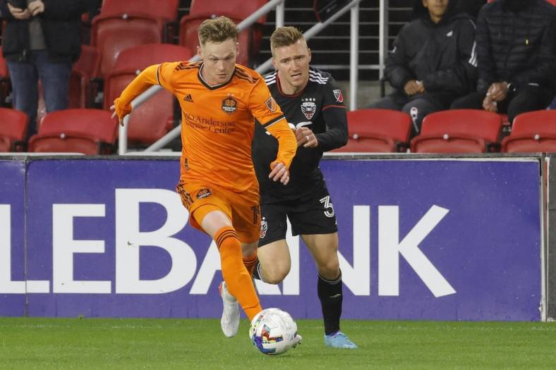 May 7, 2022; Washington, District of Columbia, USA; Houston Dynamo forward Tyler Pasher (19) dribbles the ball as D.C. United defender Julian Gressel (31) chases in the first half at Audi Field. Mandatory Credit: Geoff Burke-USA TODAY Sports
