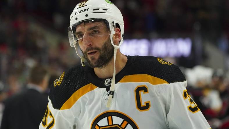 May 14, 2022; Raleigh, North Carolina, USA; Boston Bruins center Patrice Bergeron (37) leaves the ice after the game against the Carolina Hurricanes in game seven of the first round of the 2022 Stanley Cup Playoffs at PNC Arena. Mandatory Credit: James Guillory-USA TODAY Sports