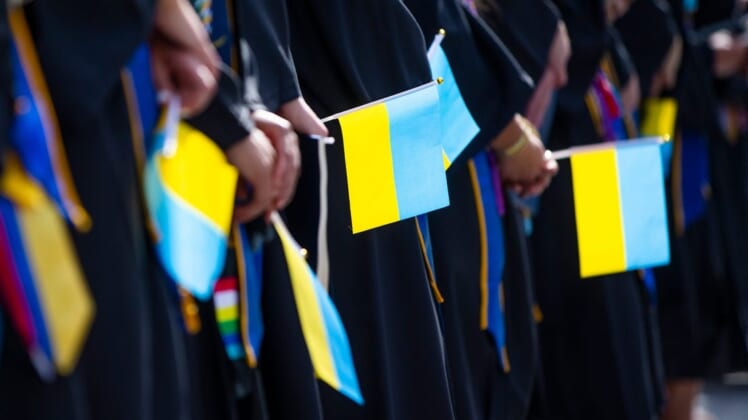 Graduates hold Ukrainian flags during the Notre Dame Commencement ceremony Sunday, May 15, 2022 at Notre Dame Stadium in South Bend.Notre Dame Commencement