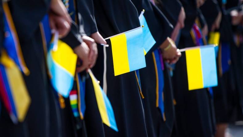 Graduates hold Ukrainian flags during the Notre Dame Commencement ceremony Sunday, May 15, 2022 at Notre Dame Stadium in South Bend.

Notre Dame Commencement