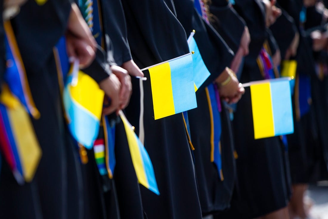Graduates hold Ukrainian flags during the Notre Dame Commencement ceremony Sunday, May 15, 2022 at Notre Dame Stadium in South Bend.

Notre Dame Commencement