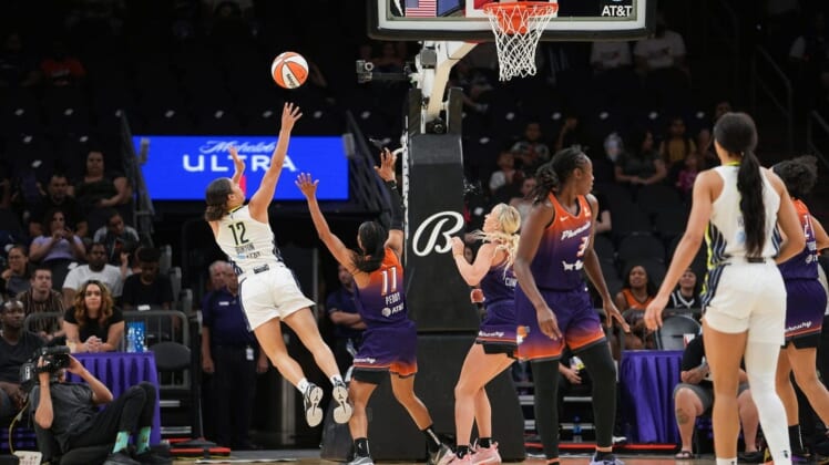 Dallas Wings guard Veronica Burton (12), left, shoots the ball while off balance during the second half against the Dallas Wings at the Footprint Center on Thursday, May 19, 2022, in Phoenix. The Mercury lost 84 to 94.Uscp 7l2kp07z4a912iwb01rk2 Original