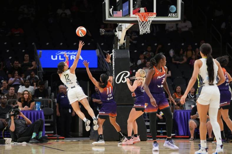 Dallas Wings guard Veronica Burton (12), left, shoots the ball while off balance during the second half against the Dallas Wings at the Footprint Center on Thursday, May 19, 2022, in Phoenix. The Mercury lost 84 to 94.

Uscp 7l2kp07z4a912iwb01rk2 Original