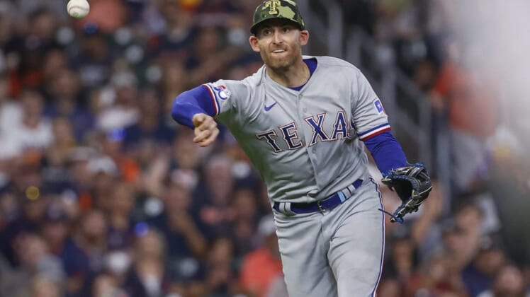 May 20, 2022; Houston, Texas, USA; Texas Rangers third baseman Brad Miller (13) throws out a runner during the third inning against the Houston Astros at Minute Maid Park. Mandatory Credit: Troy Taormina-USA TODAY Sports