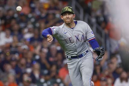 May 20, 2022; Houston, Texas, USA; Texas Rangers third baseman Brad Miller (13) throws out a runner during the third inning against the Houston Astros at Minute Maid Park. Mandatory Credit: Troy Taormina-USA TODAY Sports