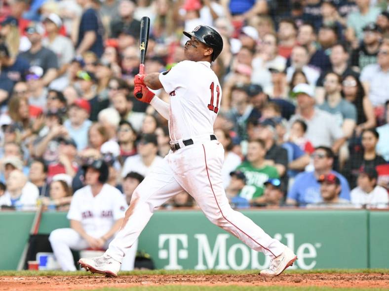 May 21, 2022; Boston, Massachusetts, USA; Boston Red Sox third baseman Rafael Devers (11) watches the ball after hitting a two-run home run against the Seattle Mariners during the fifth inning at Fenway Park. Mandatory Credit: Brian Fluharty-USA TODAY Sports