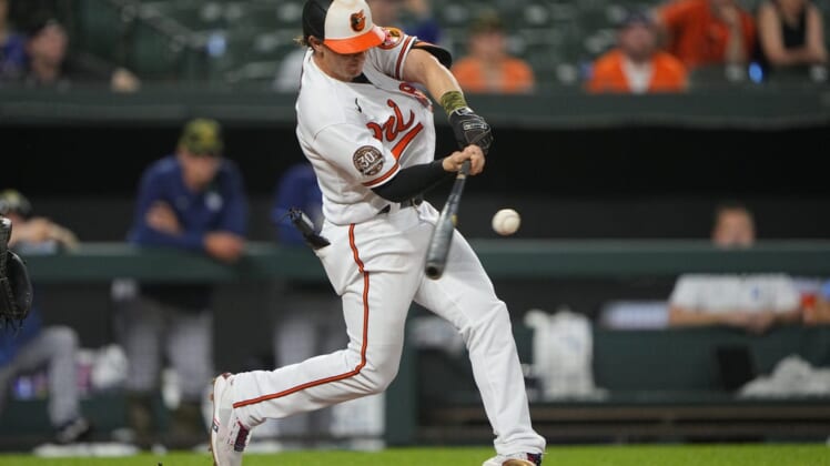 May 22, 2022; Baltimore, Maryland, USA; Baltimore Orioles left fielder Austin Hays (21) hits an RBI single during the ninth inning against the Tampa Bay Rays at Oriole Park at Camden Yards. Mandatory Credit: Gregory Fisher-USA TODAY Sports