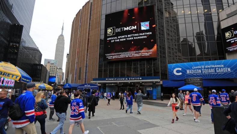 May 24, 2022; New York, New York, USA; The Empire State Building is seen in the distance as New York Rangers fans walk into Madison Square Garden before game four of the second round of the 2022 Stanley Cup Playoffs between the Rangers and Carolina Hurricanes at Madison Square Garden. Mandatory Credit: Danny Wild-USA TODAY Sports