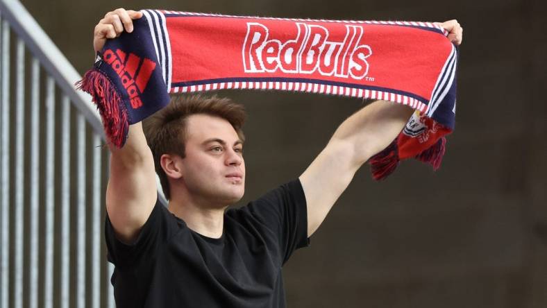 May 18, 2022; Harrison, New Jersey, USA; A fan holds a Red Bulls scarf before the game between the New York Red Bulls and the Chicago Fire at Red Bull Arena. Mandatory Credit: Vincent Carchietta-USA TODAY Sports