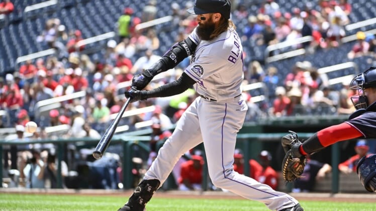 May 28, 2022; Washington, District of Columbia, USA; Colorado Rockies right fielder Charlie Blackmon (19) hits a single against the Washington Nationals during the first inning at Nationals Park. Mandatory Credit: Brad Mills-USA TODAY Sports
