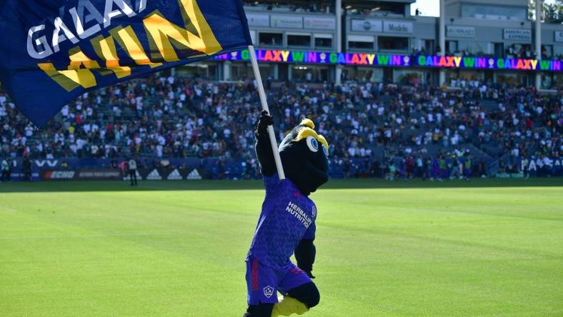 May 29, 2022; Carson, California, USA; Los Angeles Galaxy mascot Cozmo celebrates the victory against Austin FC at Dignity Health Sports Park. Mandatory Credit: Gary A. Vasquez-USA TODAY Sports