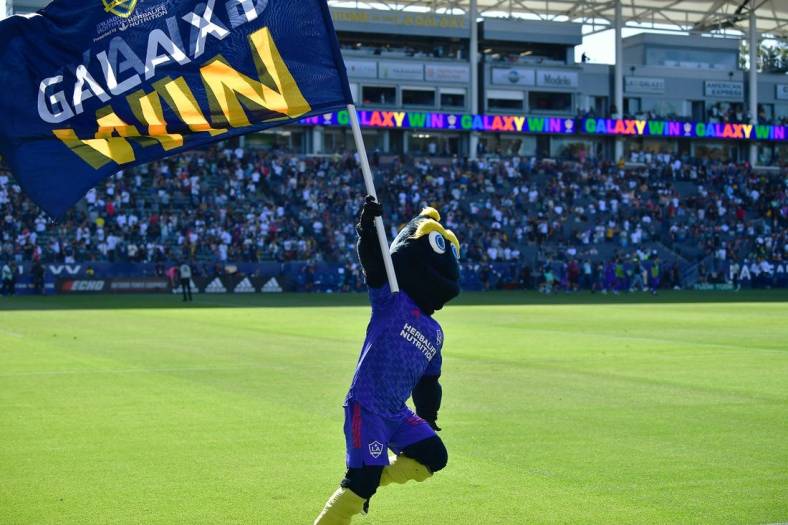 May 29, 2022; Carson, California, USA; Los Angeles Galaxy mascot Cozmo celebrates the victory against Austin FC at Dignity Health Sports Park. Mandatory Credit: Gary A. Vasquez-USA TODAY Sports