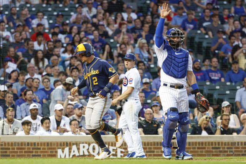May 31, 2022; Chicago, Illinois, USA; Milwaukee Brewers shortstop Luis Urias (2) scores on a double hit by center fielder Tyrone Taylor against the Chicago Cubs during the third inning at Wrigley Field. Mandatory Credit: Kamil Krzaczynski-USA TODAY Sports